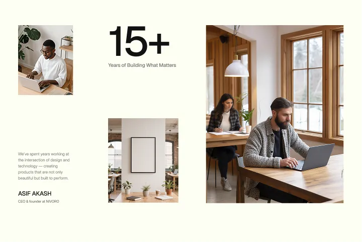 Man and woman working on laptops at wooden tables in a bright room with large windows and plants.