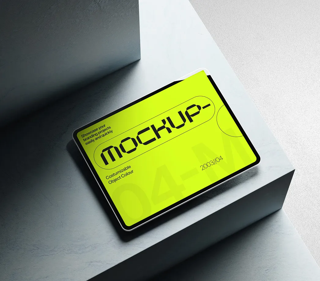 Tablet with bright yellow screen displaying MOCKUP text on gray stone steps under soft light.