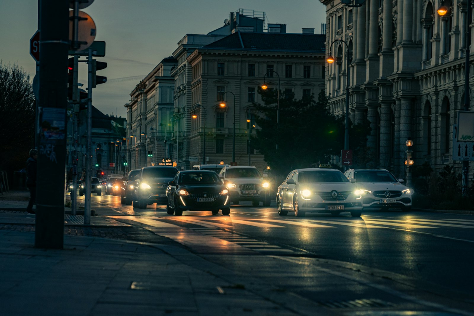 A busy street in Vienna at night with traffic and lights, for a guide to Vienna nightlife by neighbourhood