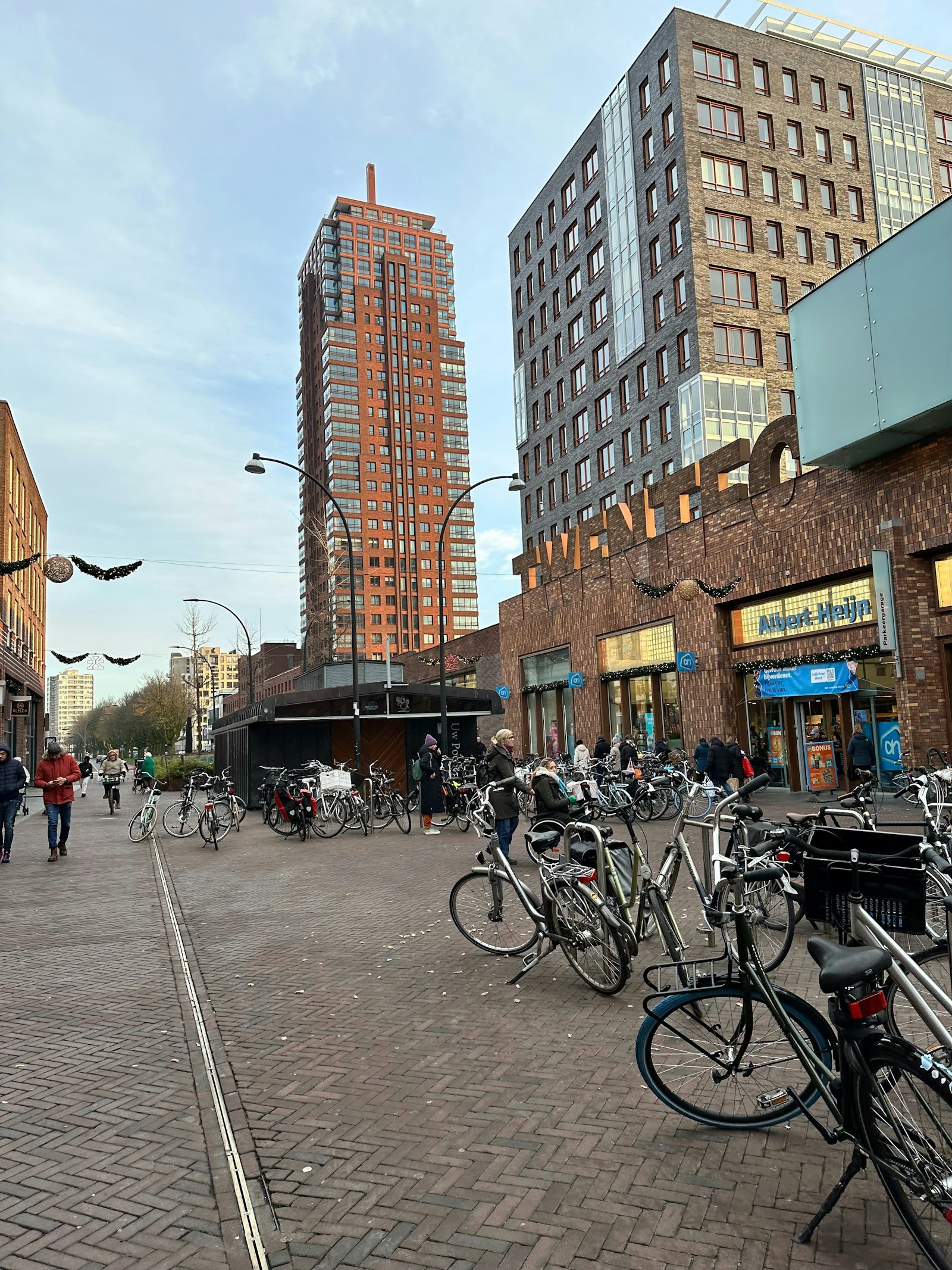 The Oude Markt in Enschede with people and bicycles, cover image for the 9 best bars in Enschede
