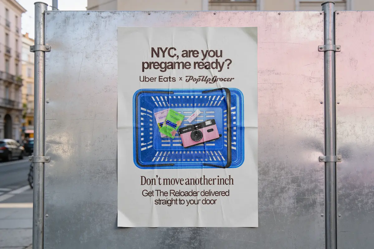 Poster on metal board: NYC, are you pregame ready? Uber Eats x PopUpGrocer with blue basket and items inside.