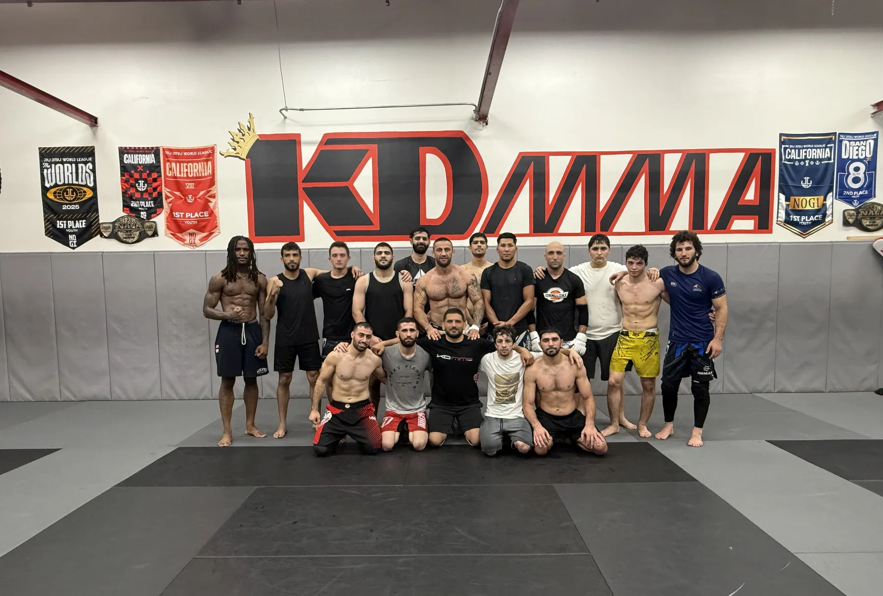 KD MMA team group photo under the gym banner at the Glendale academy