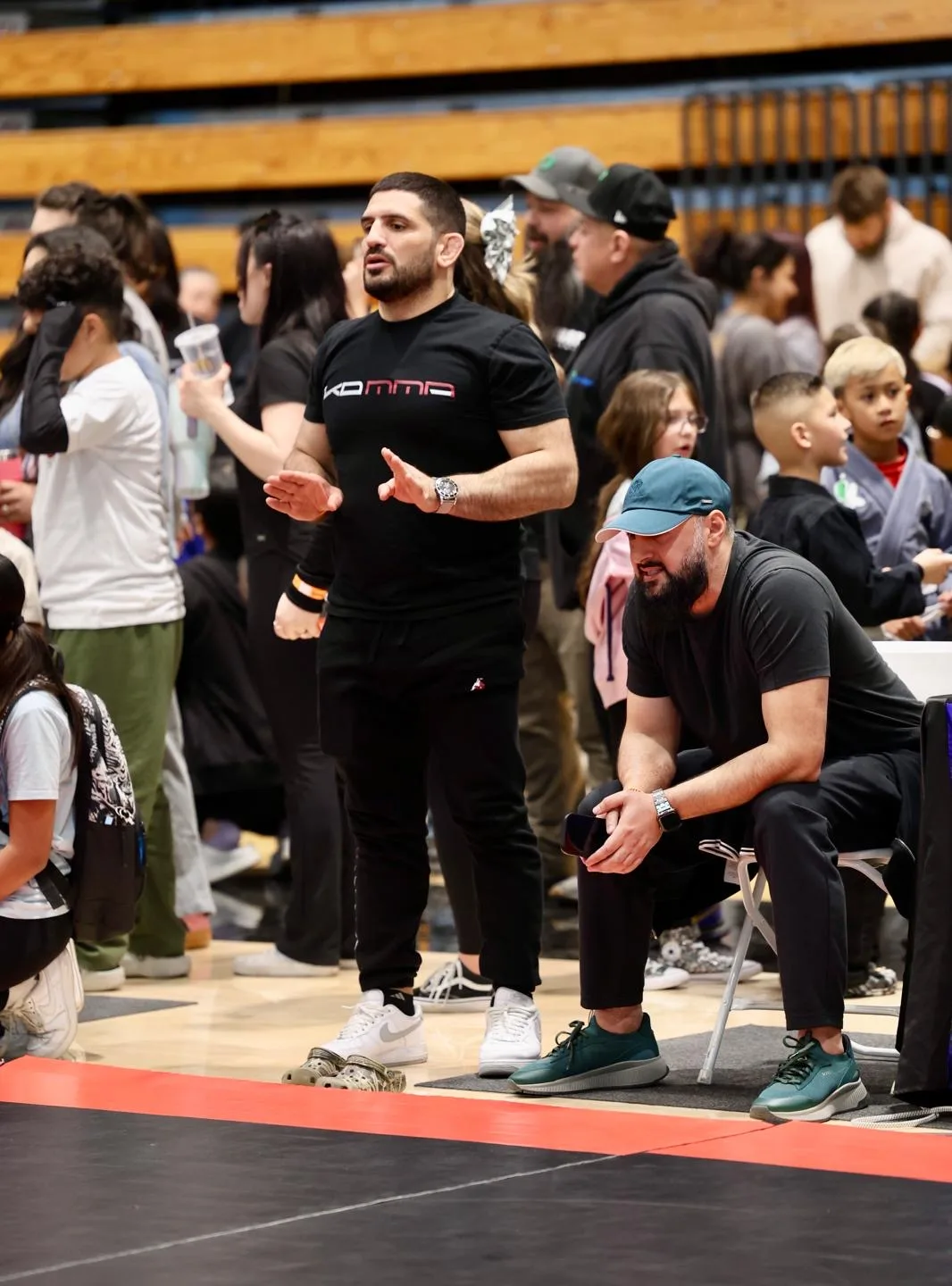 KD MMA coach supporting his athletes at a grappling tournament