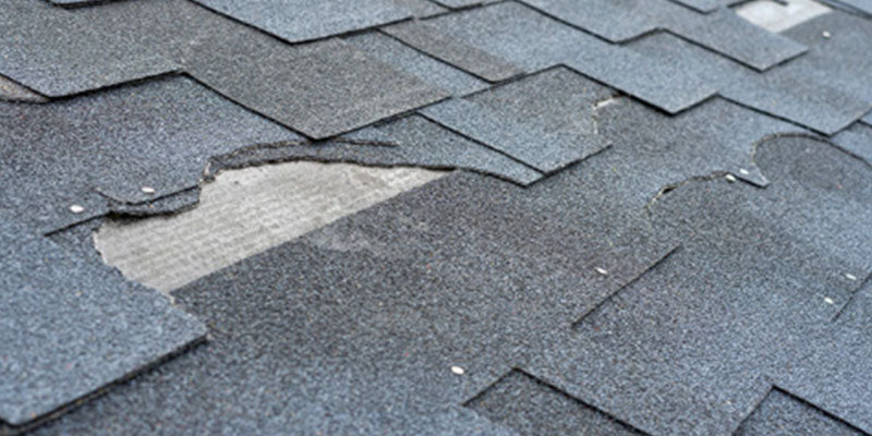 storm damage on asphalt shingle roof