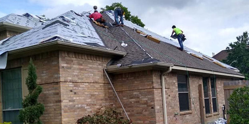 Crew installing a brand new asphalt shingle roof on a Cleveland, Ohio home