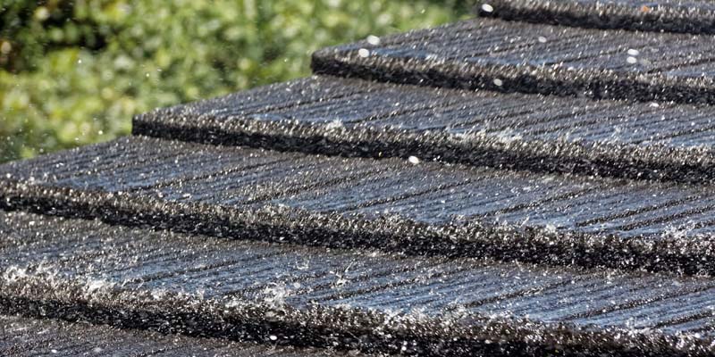 rain pouring down on stone coated metal roof by Tilcor