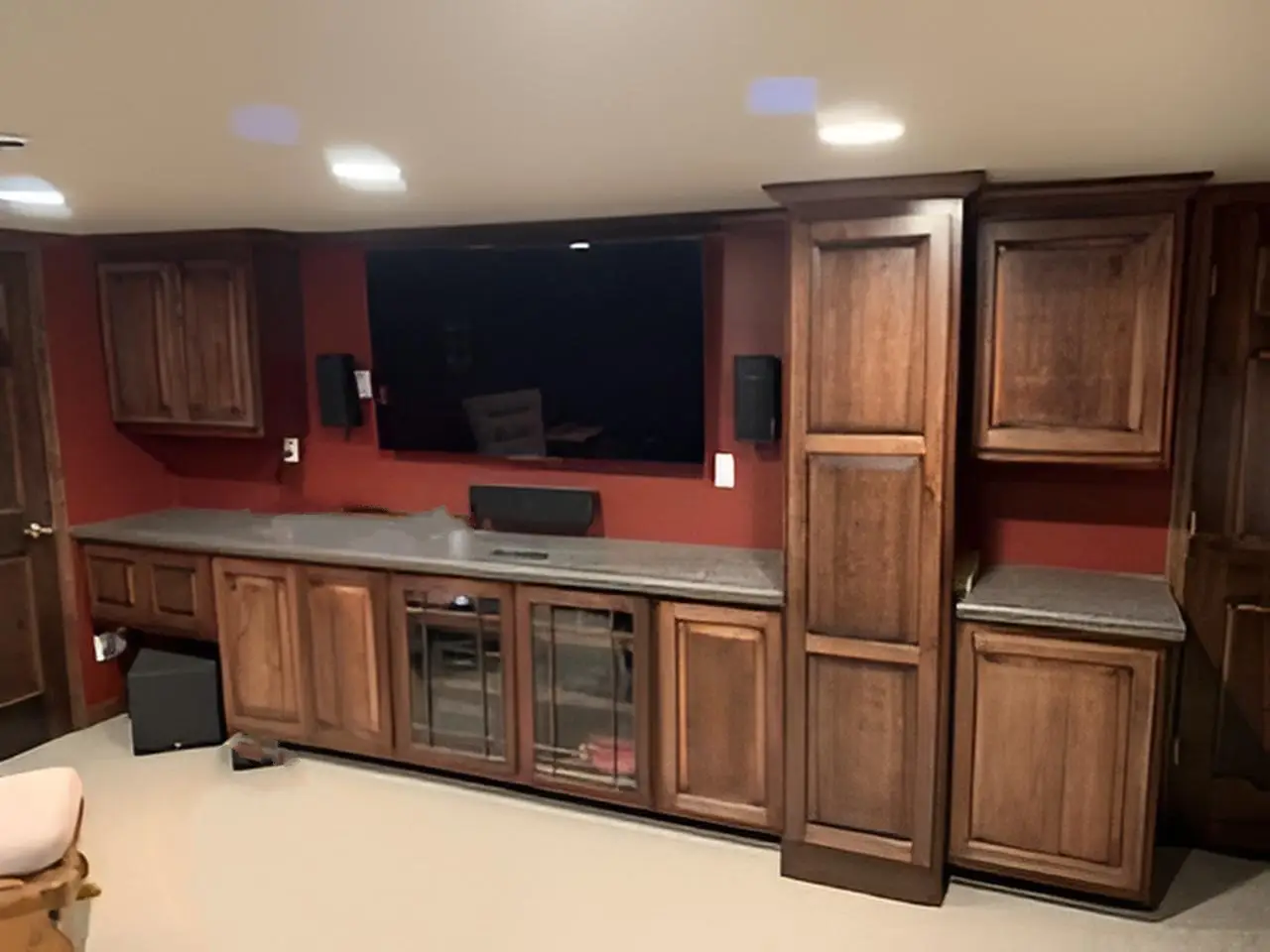 A home theater room with custom cabinets.