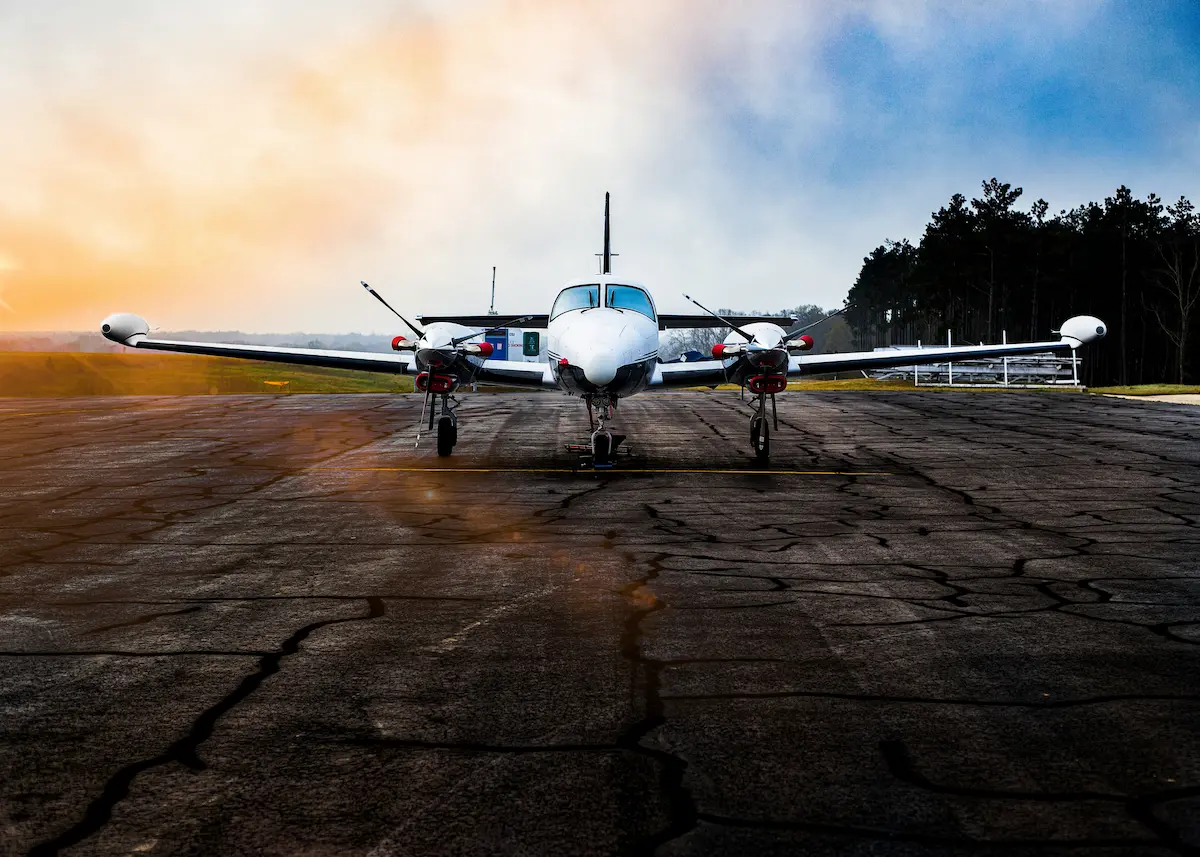 Twin-engine aircraft on runway at golden hour