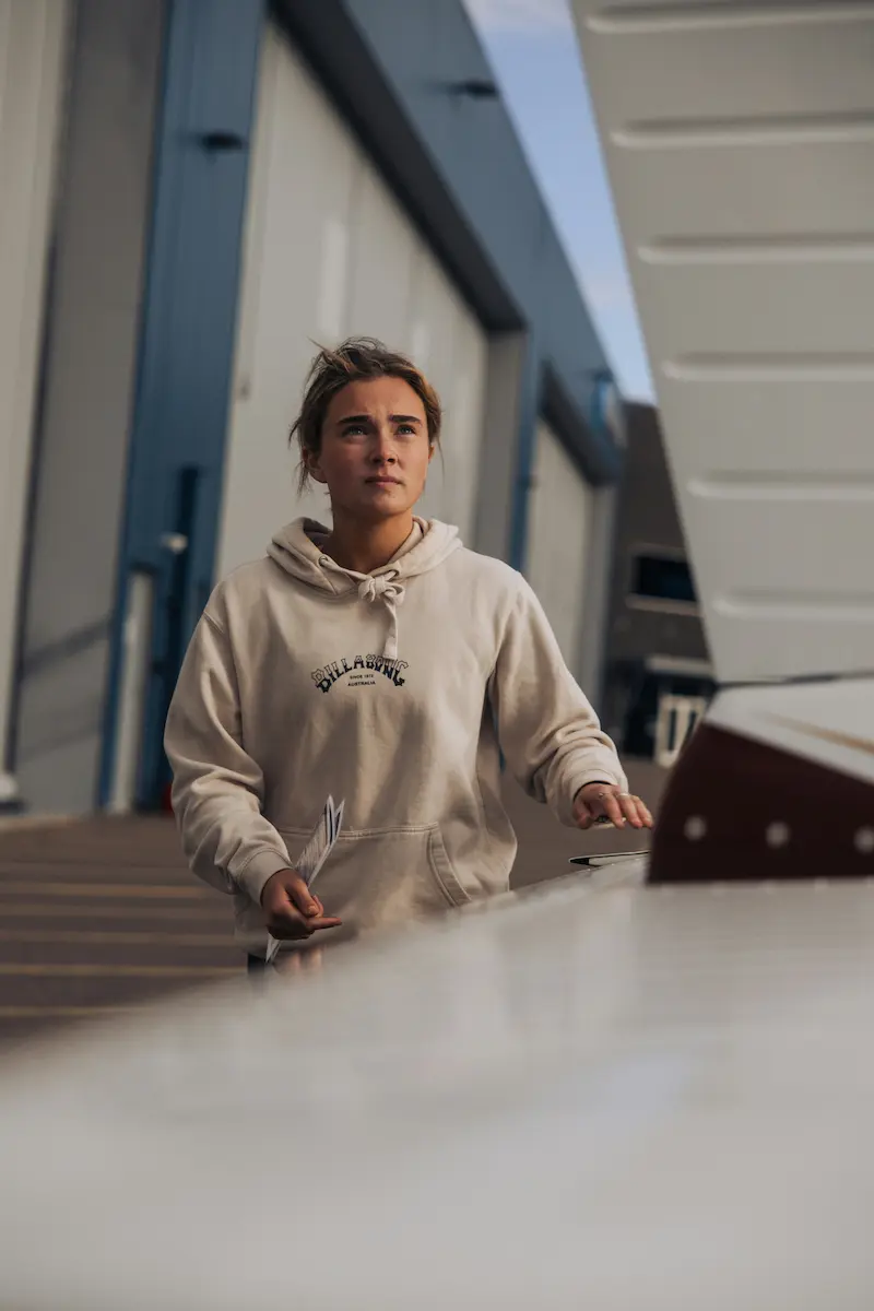 Woman doing preflight at airport hangar