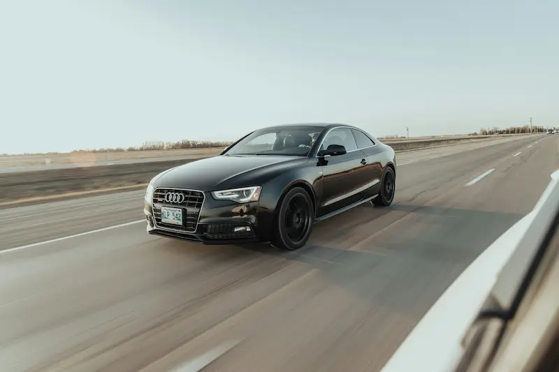 Car driving on open prairie highway