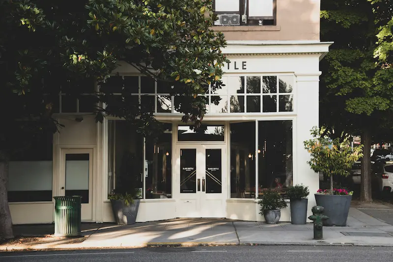 Clean small business storefront on a tree-lined street