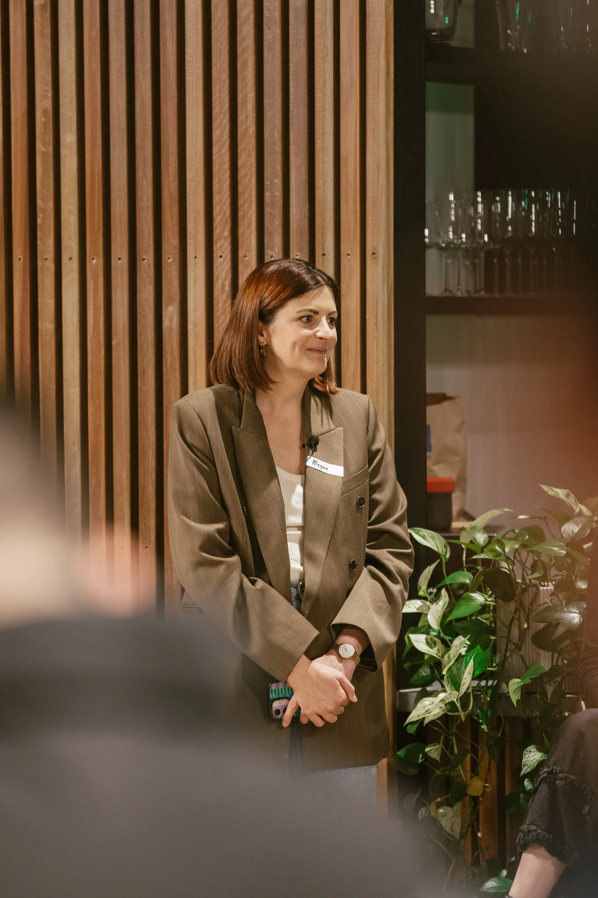 Senior leader speaking with founders at a Melbourne startup event