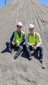 Niklas and Felix sitting on a pile of rock powder