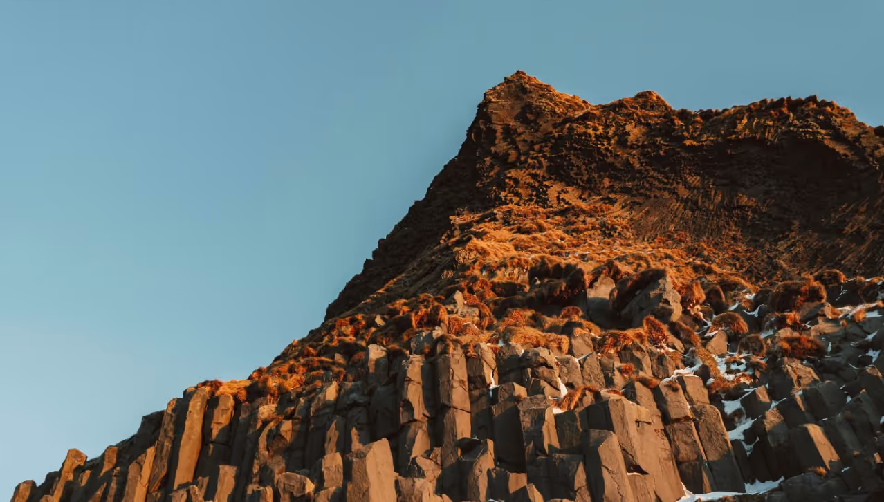 Rocks on a hill with a blue sky in the background