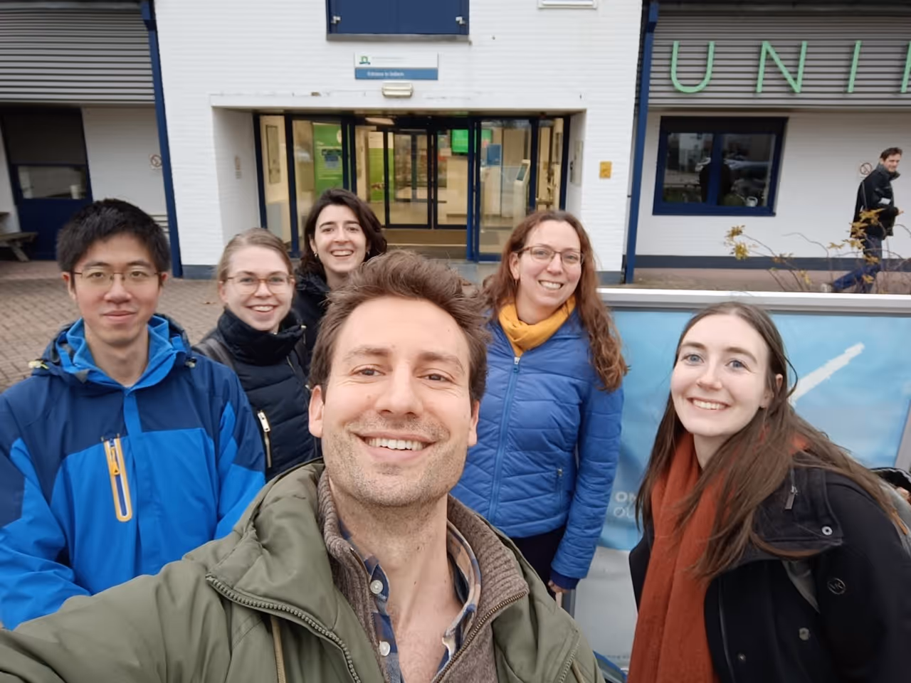 Dr. Philipp taking a selfie with a research team
