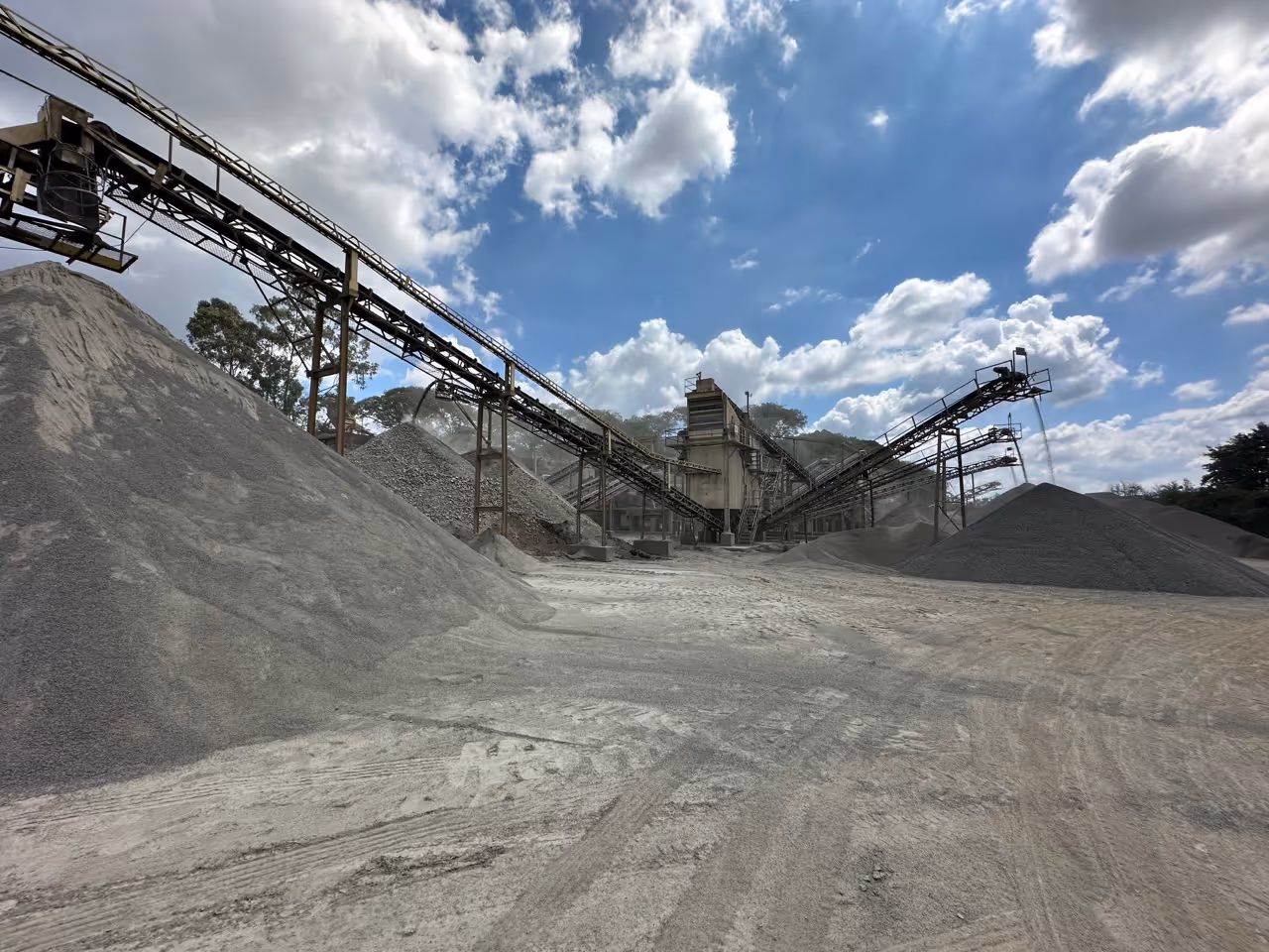 Mining equipments grinding rock powder. Piles of rock powder in the forefront.|Photos of Guimarães, Leonardos, and Theodoro