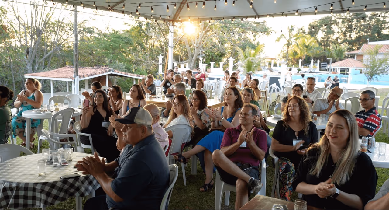 A seated group of people clapping