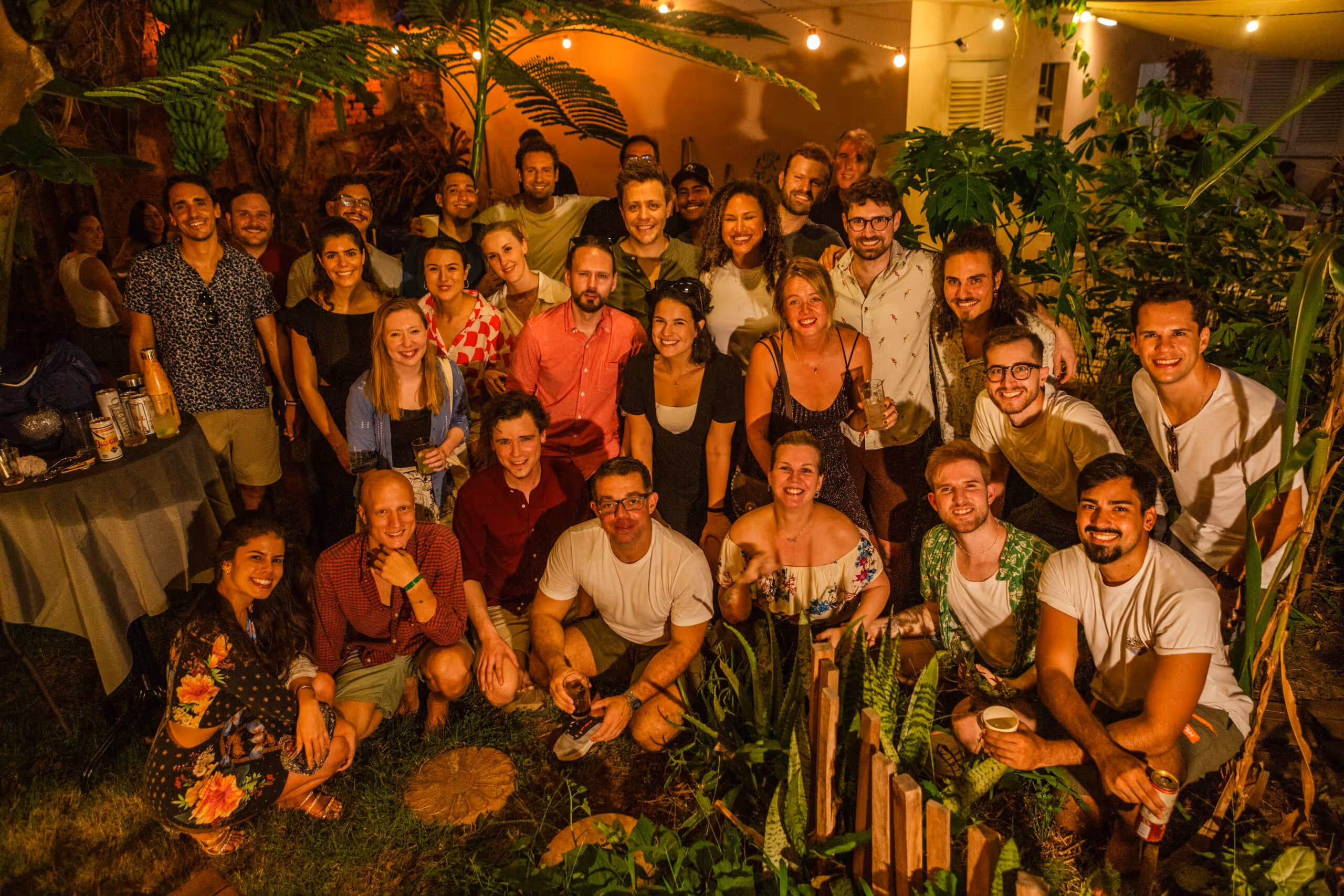 InPlanet's team gathering in a backyard. Tropical plants in the background.