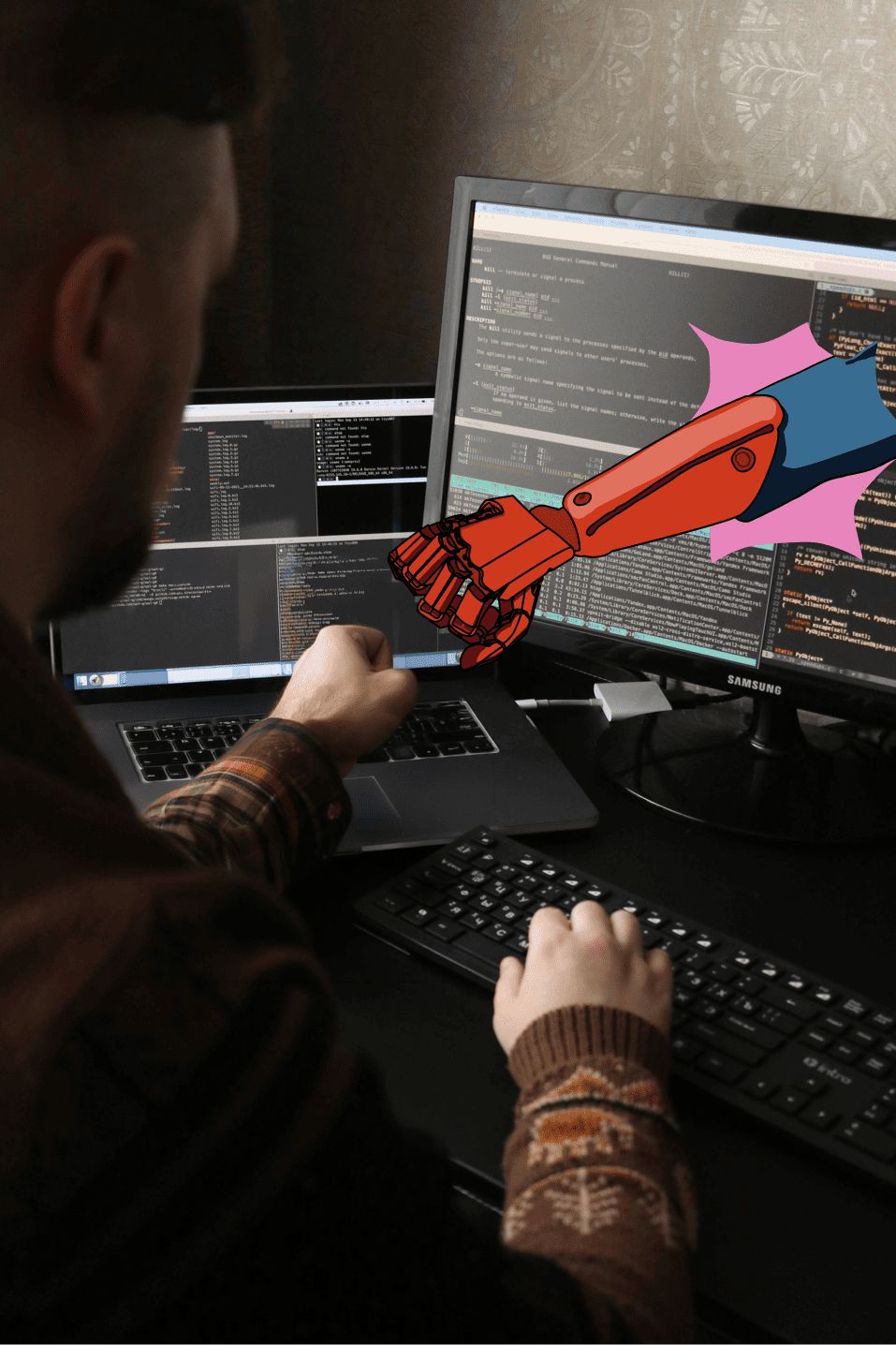 A man sitting at a desk working on a laptop and a monitor with coding displayed, fist bumping a digitally illustrated red robotic arm extending from the monitor.