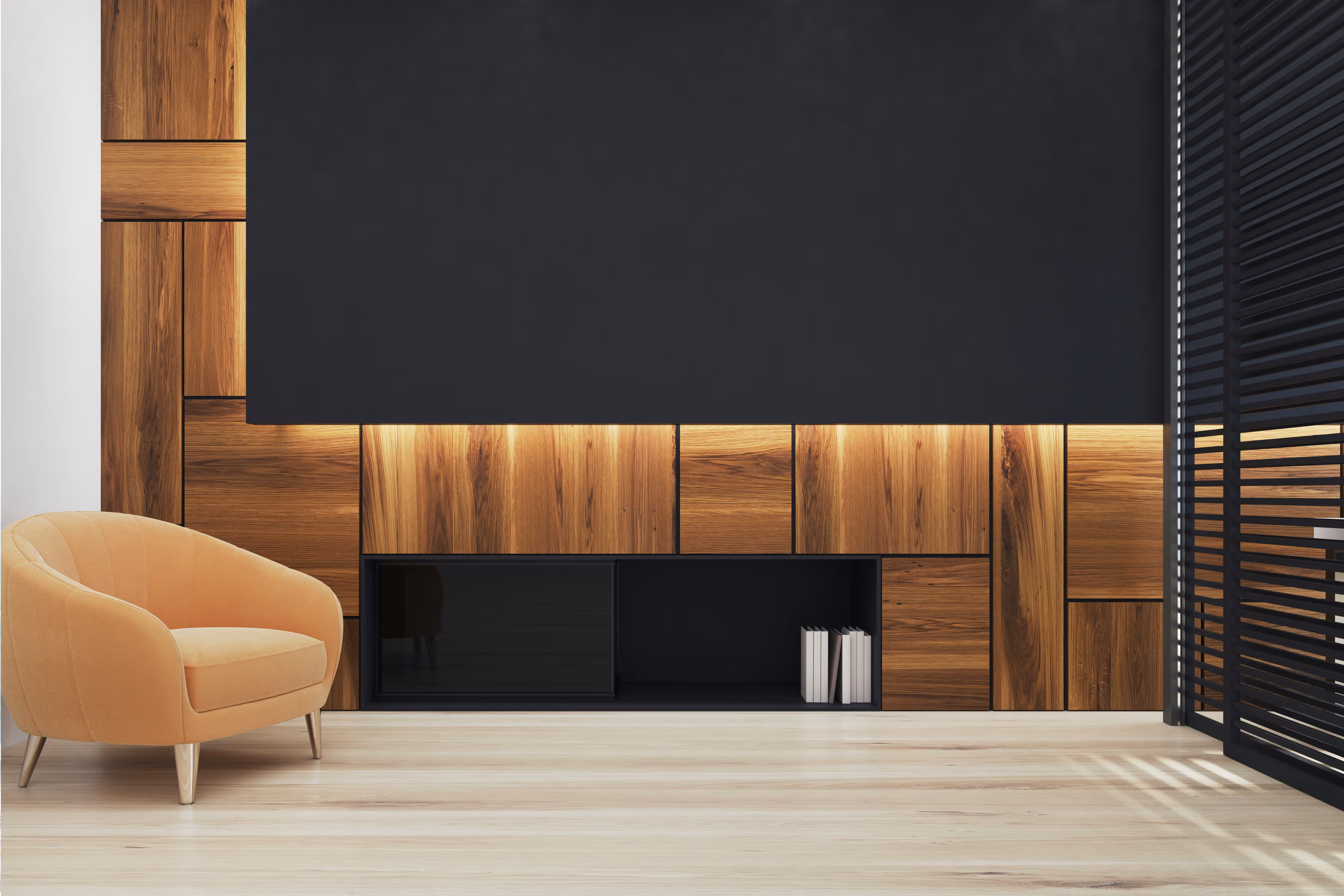 Modern living room corner with tan armchair, wood-paneled wall, black shelf, and large black screen.