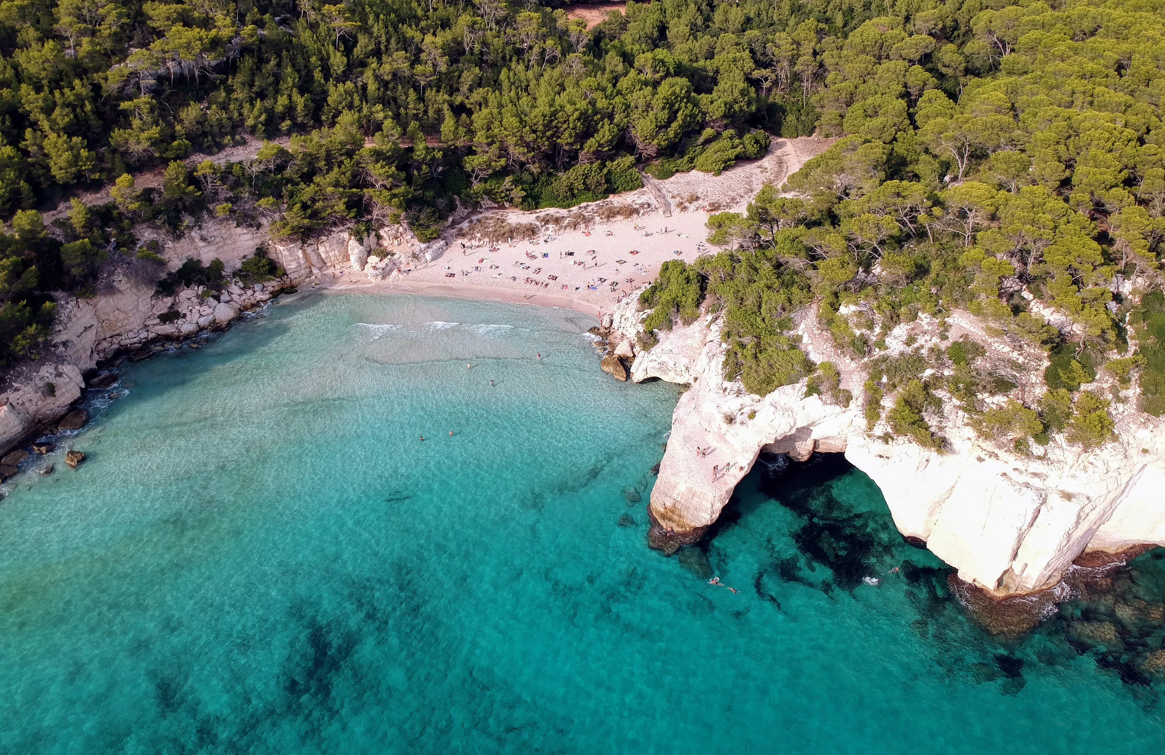 Cala Mitjana beach near Cala d’Or with clear water and natural cliffs