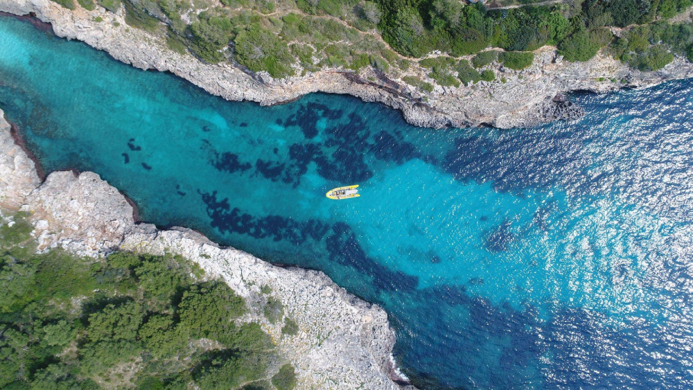 Cala Mitjana beach in Mallorca with turquoise water, sandy cove and rocky coast