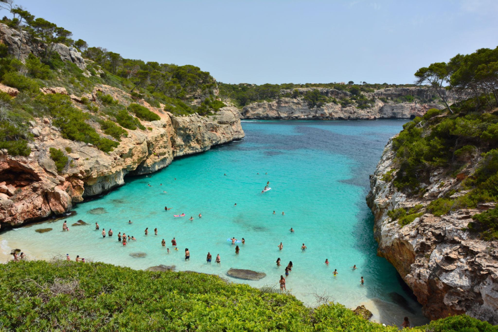 Caló des Moro beach near Santanyí with clear turquoise water and rocky cliffs
