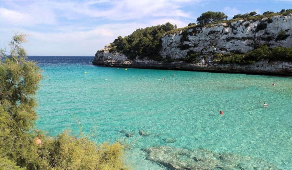 Cala Petita beach in Cala d’Or with turquoise water and small sandy shore