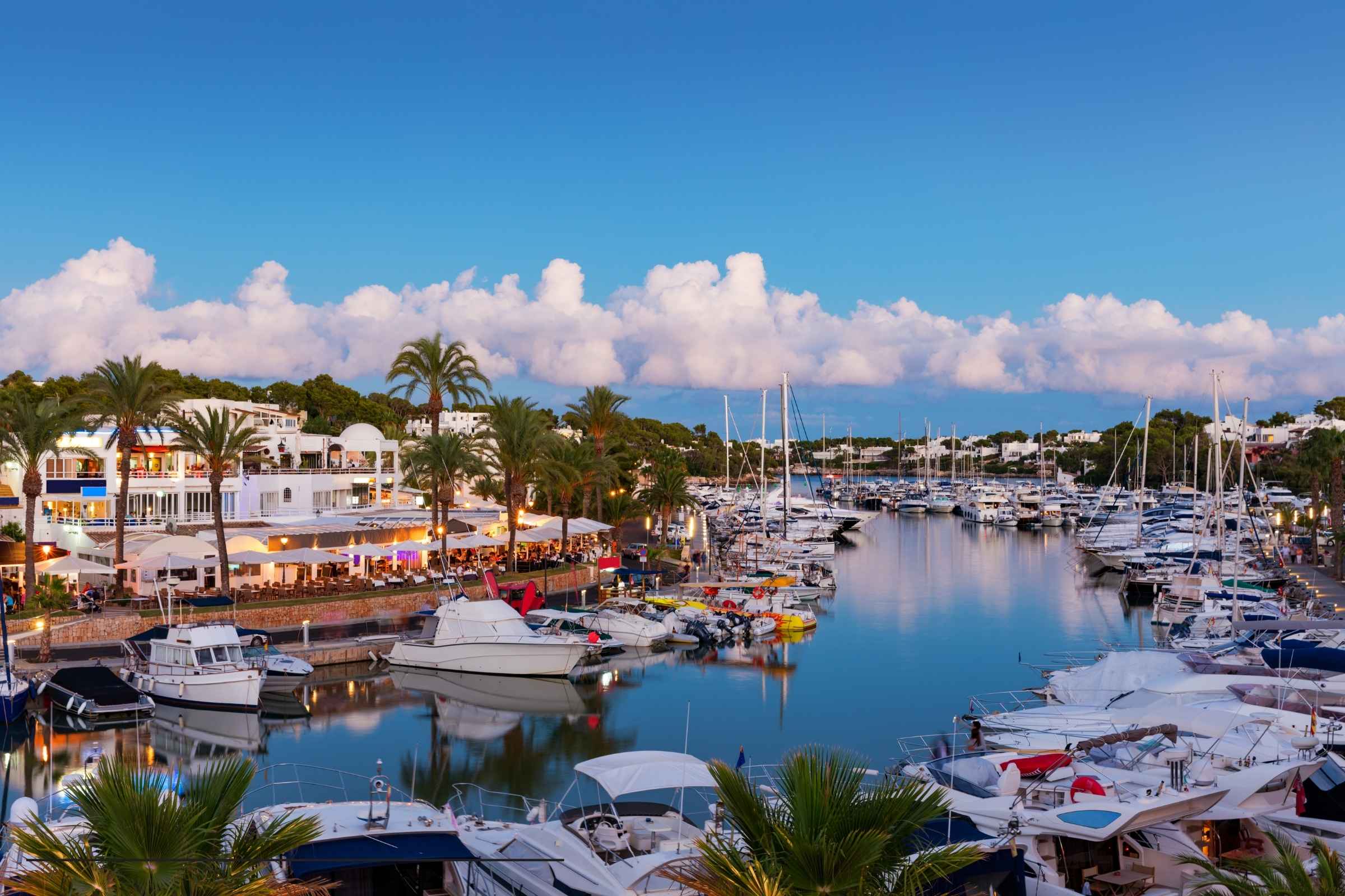 Cala d’Or Marina with boats, waterfront restaurants and terraces in Mallorca