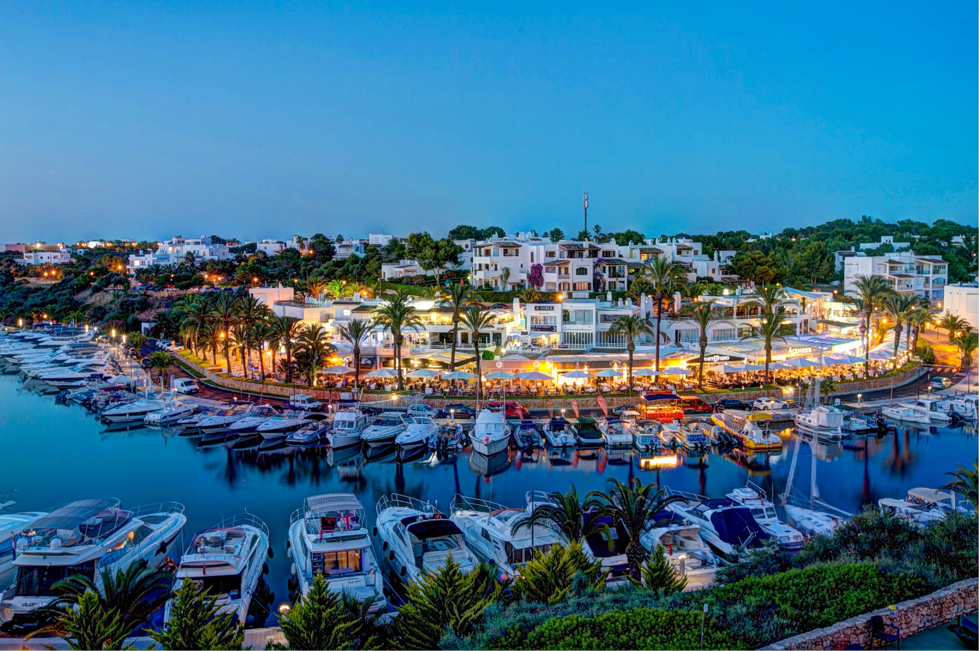 Boats and waterfront restaurants in Cala d’Or Marina, Mallorca