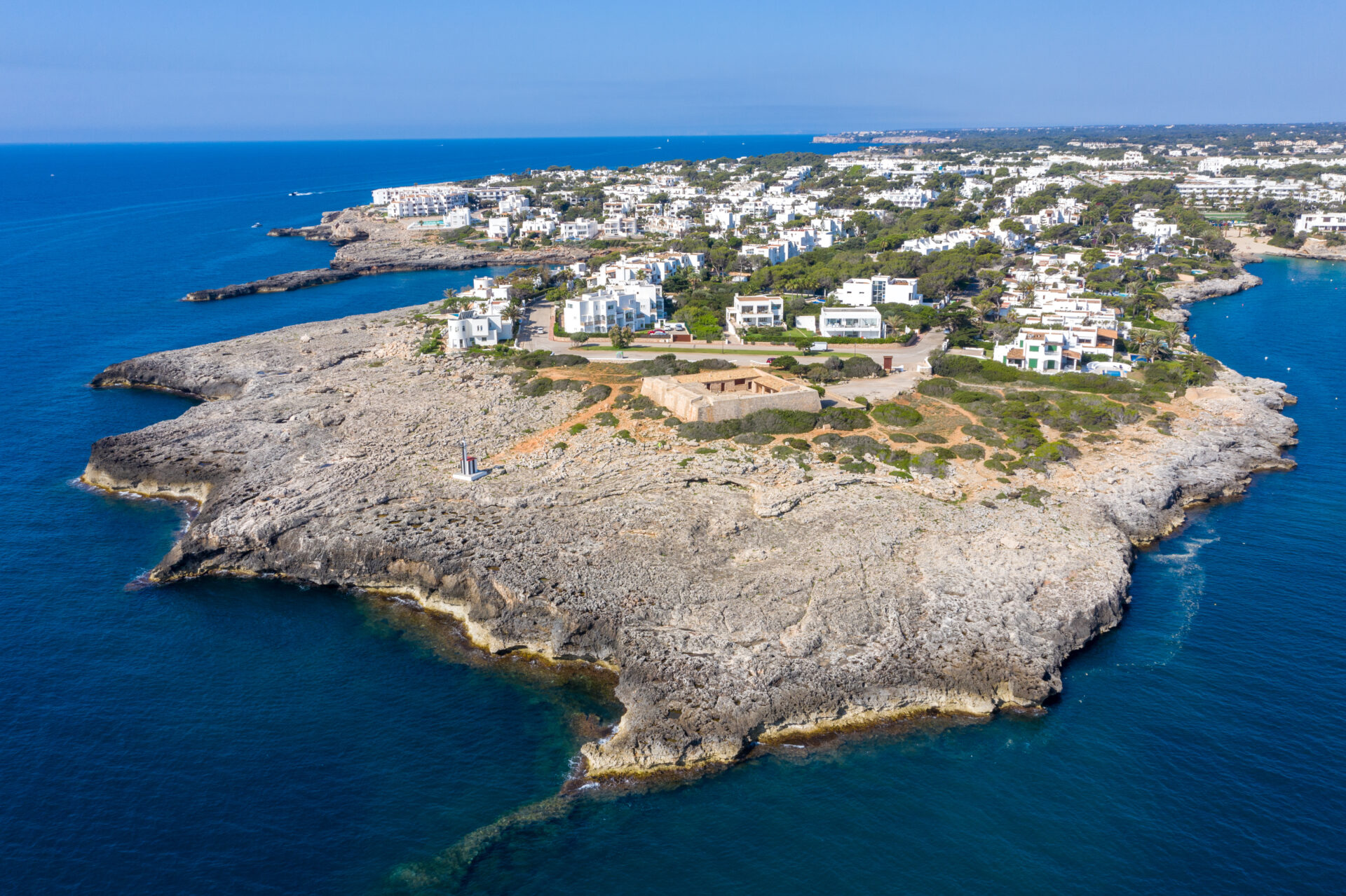 Cala d’Or coastline with turquoise coves and whitewashed resort buildings in Mallorca