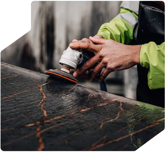 Worker wet polishing a worktop