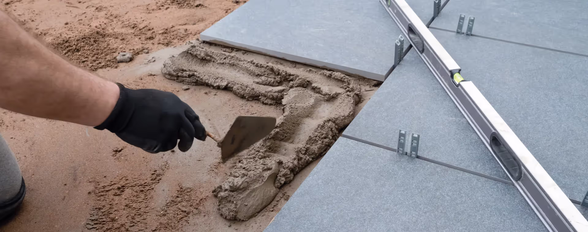 Worker laying paving slabs