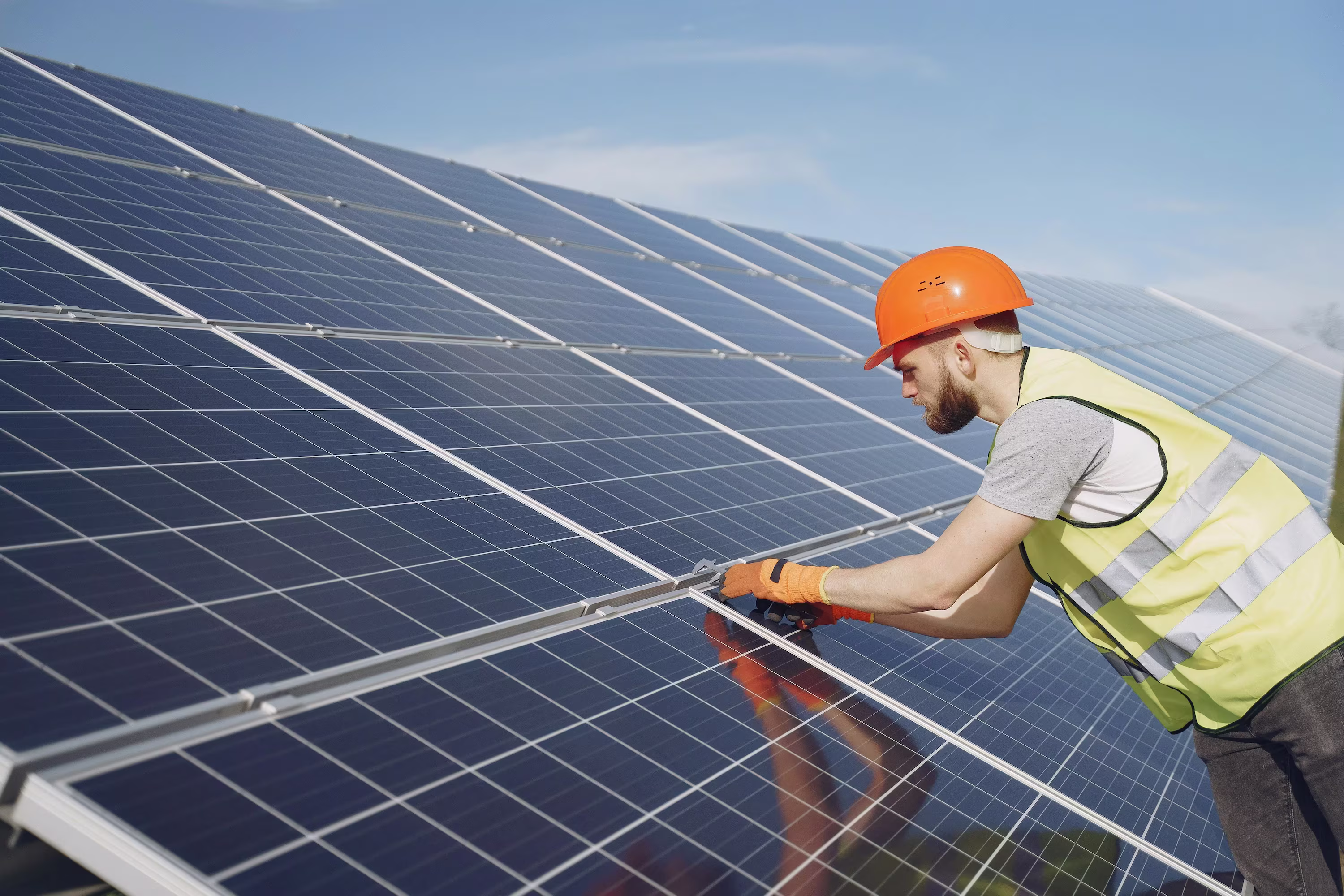 Workers inspecting solar panel