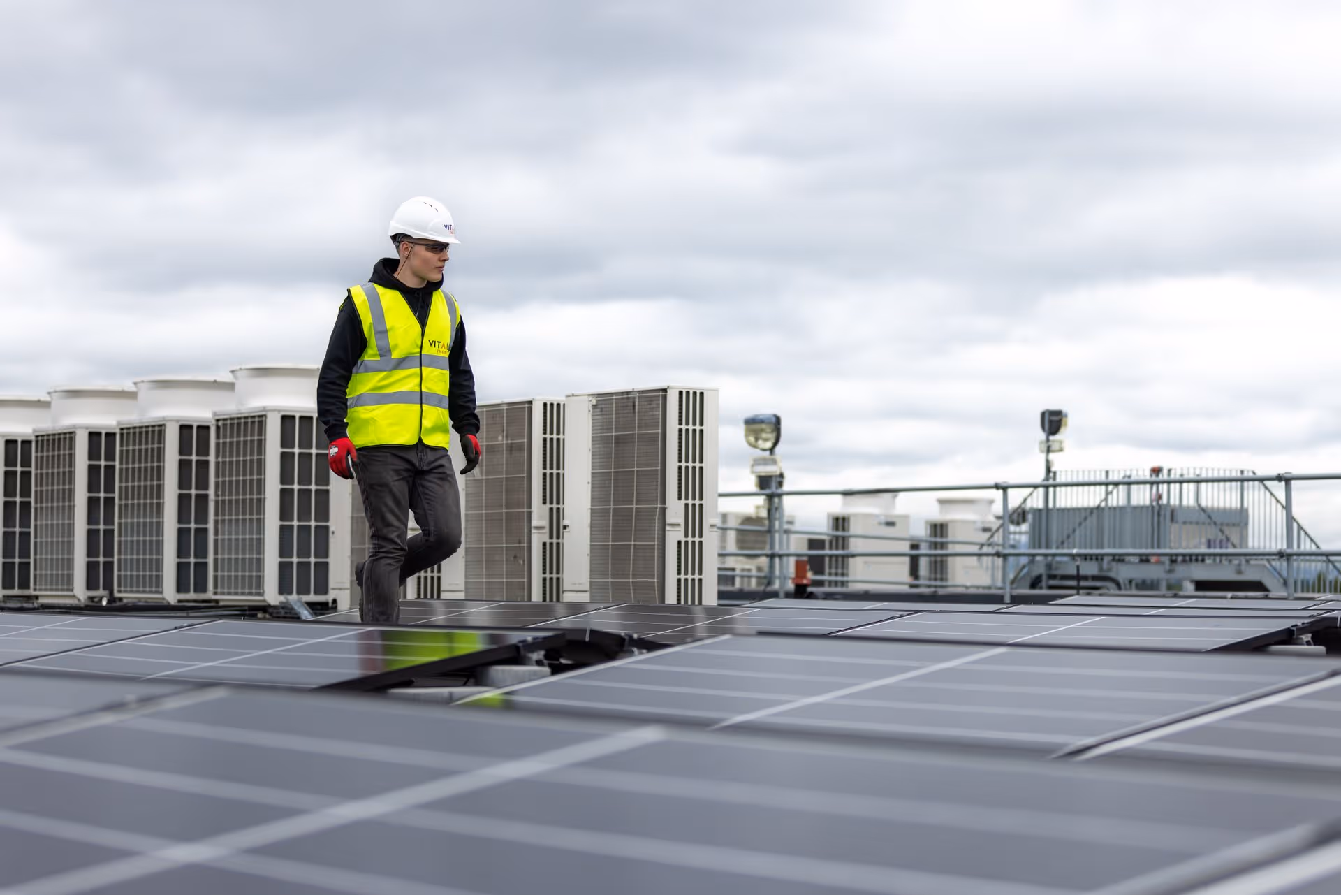 Workers on a solar panel roof