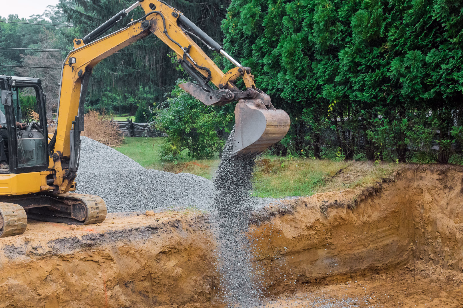 Digger digging large trench