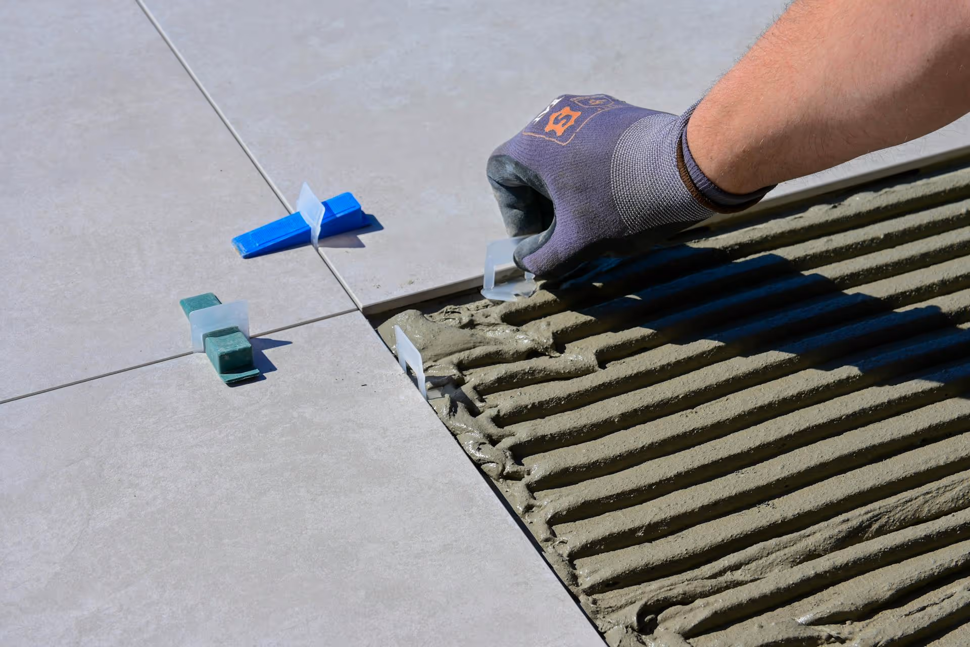 Worker laying paving slabs