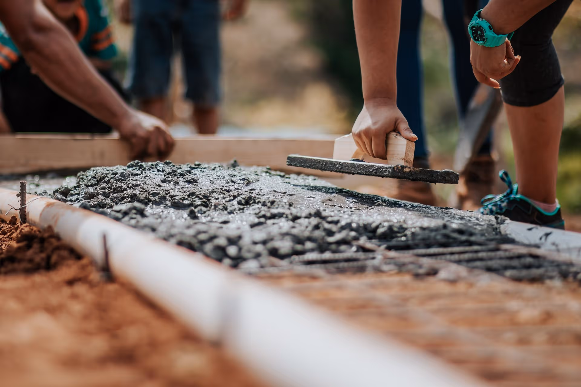 Worker laying paving slabs