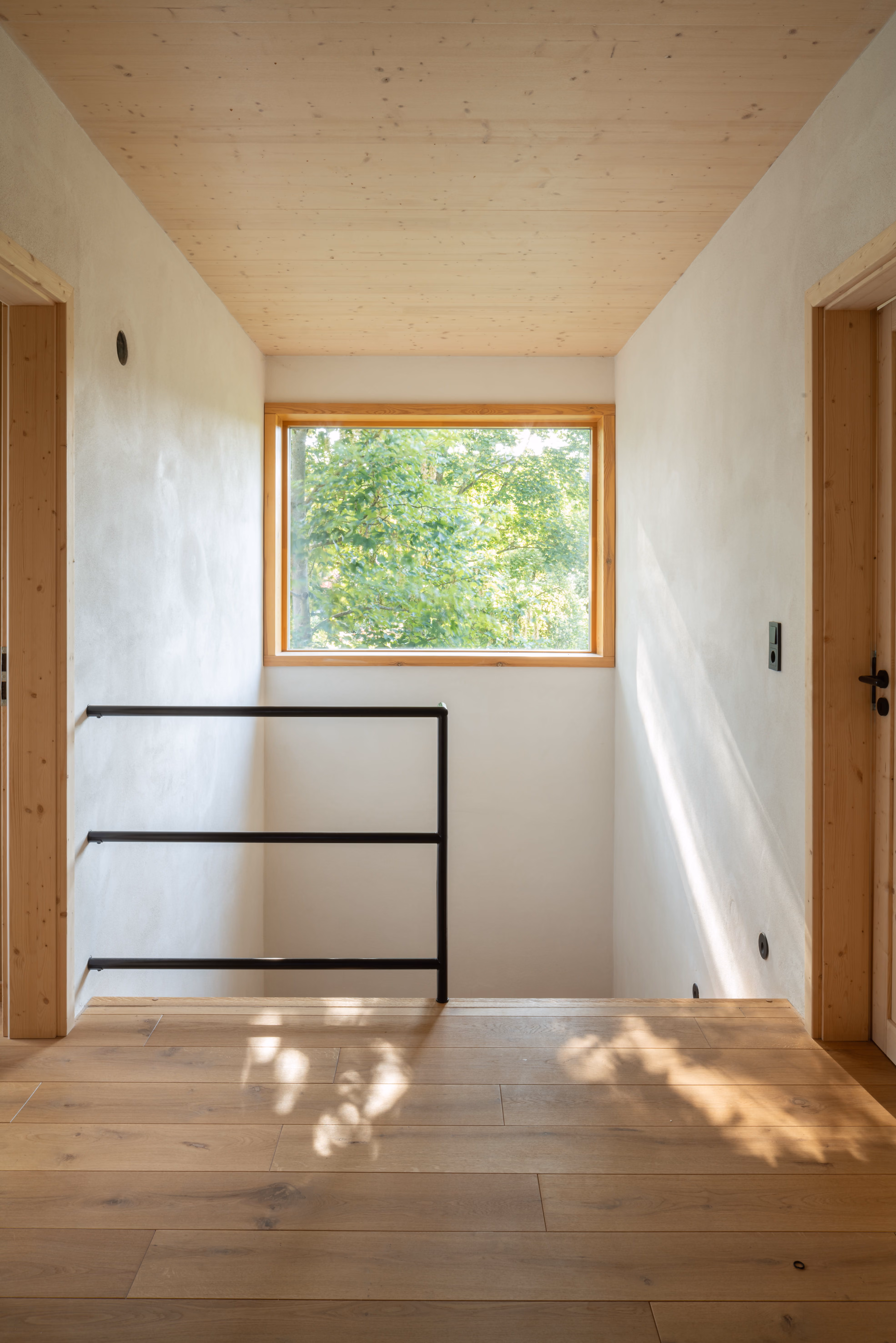 Helles Treppenhaus mit Holzkonstruktion und natürlichem Lichteinfall, Daniel Boepple Architekt