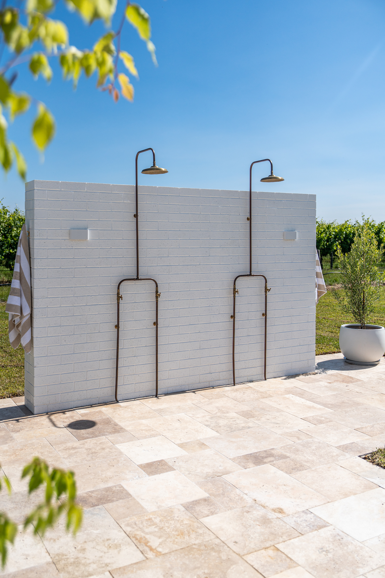 Outdoor shower facing views of the lush vineyards