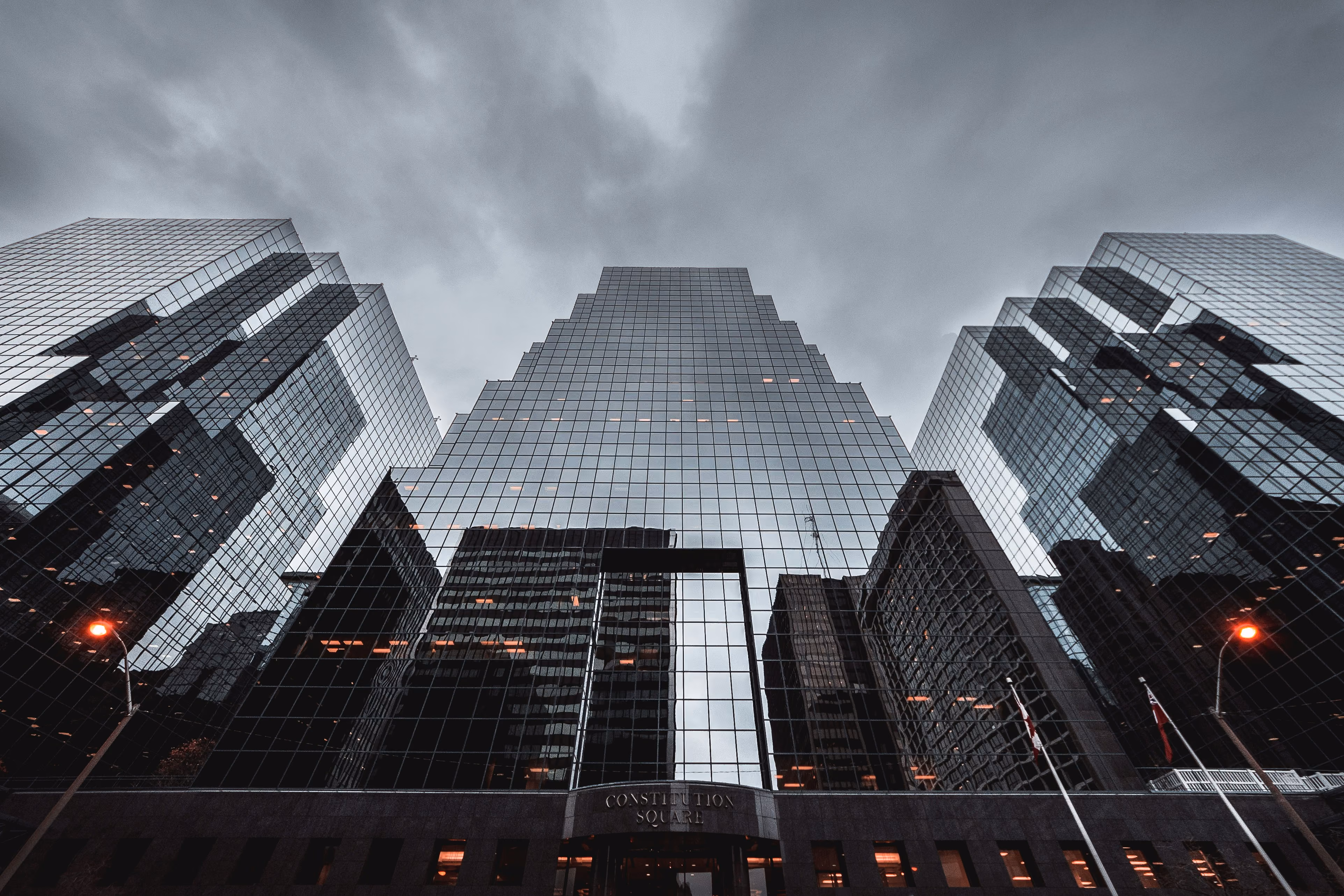 Low-angle photo of a high-rise building in Ottawa against a dark, cloudy sky