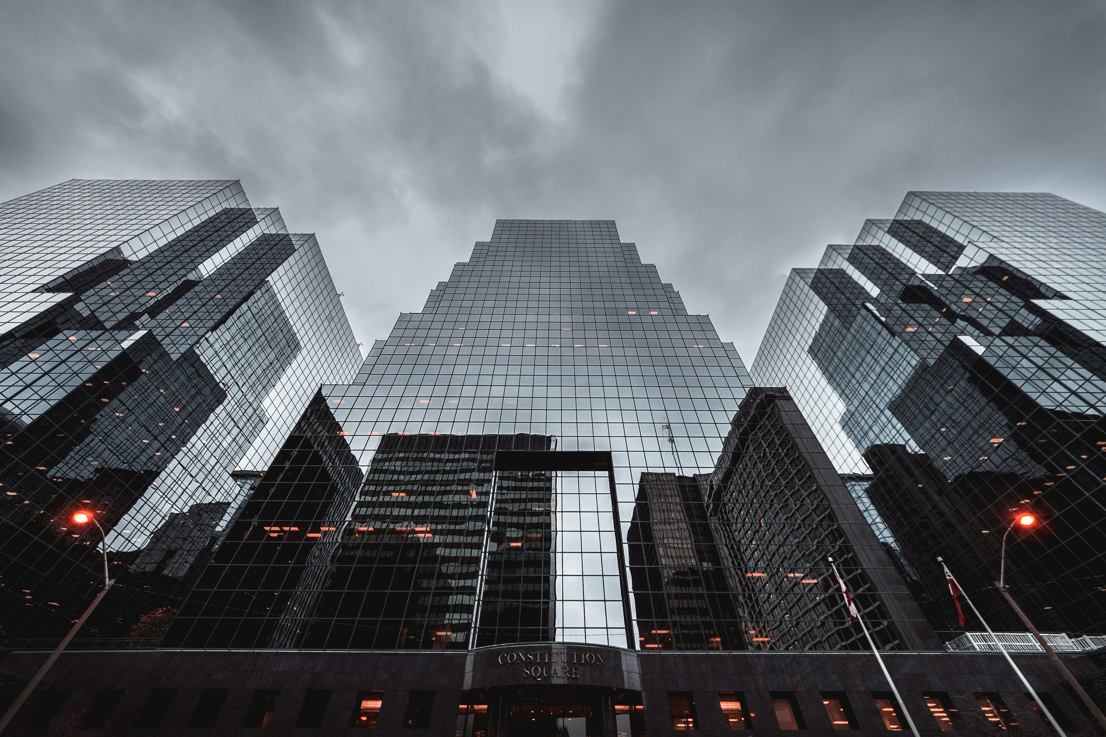 Low-angle photo of a high-rise building in Ottawa against a dark, cloudy sky