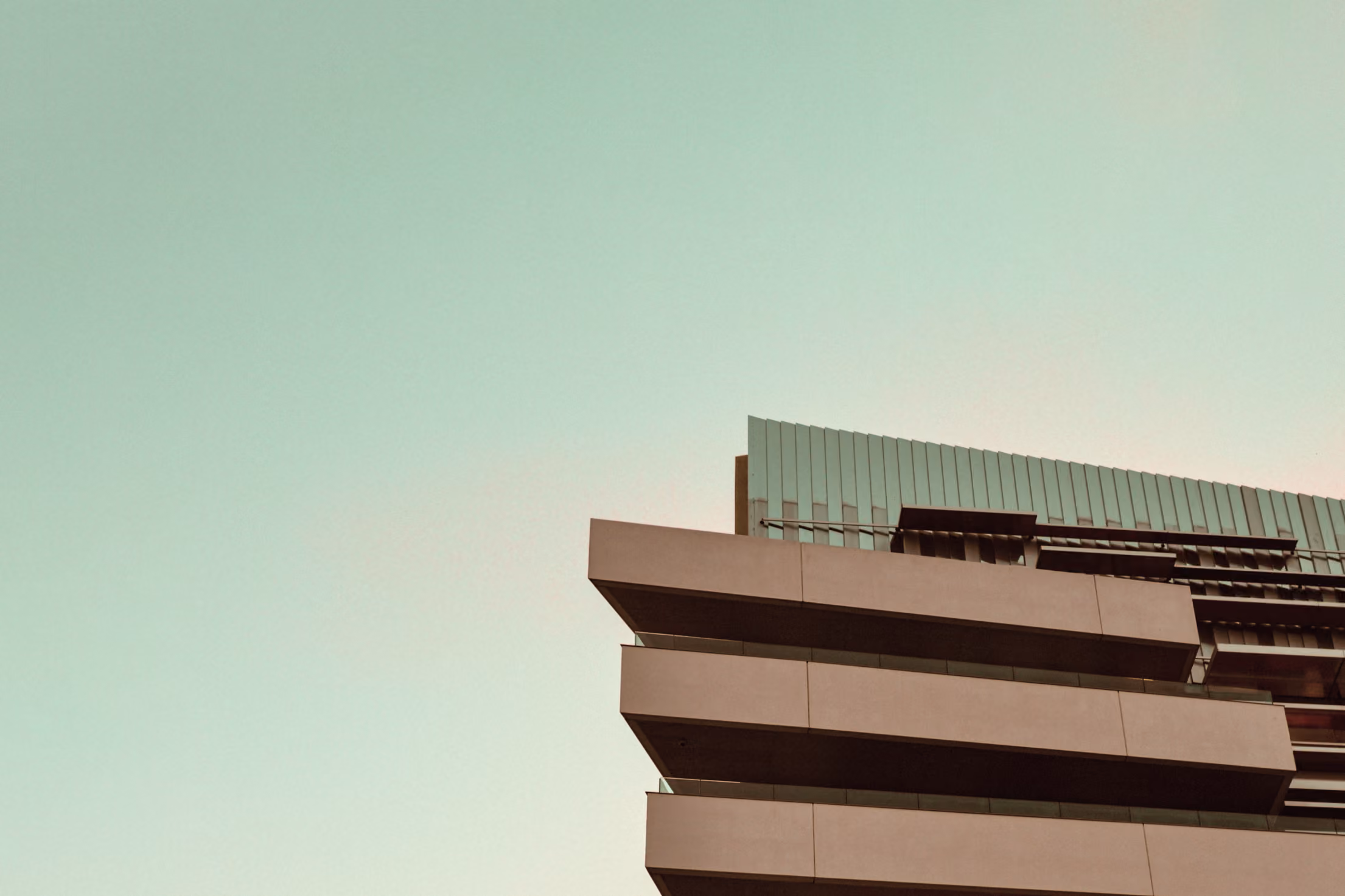 Top of a highrise building with skyline behind