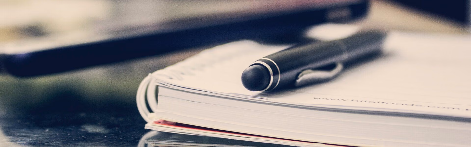 Close up shot of a pen on a notepad