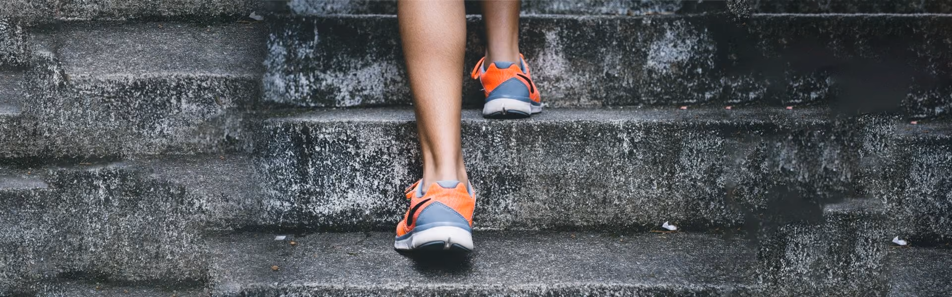 Close up of a person running up some steps