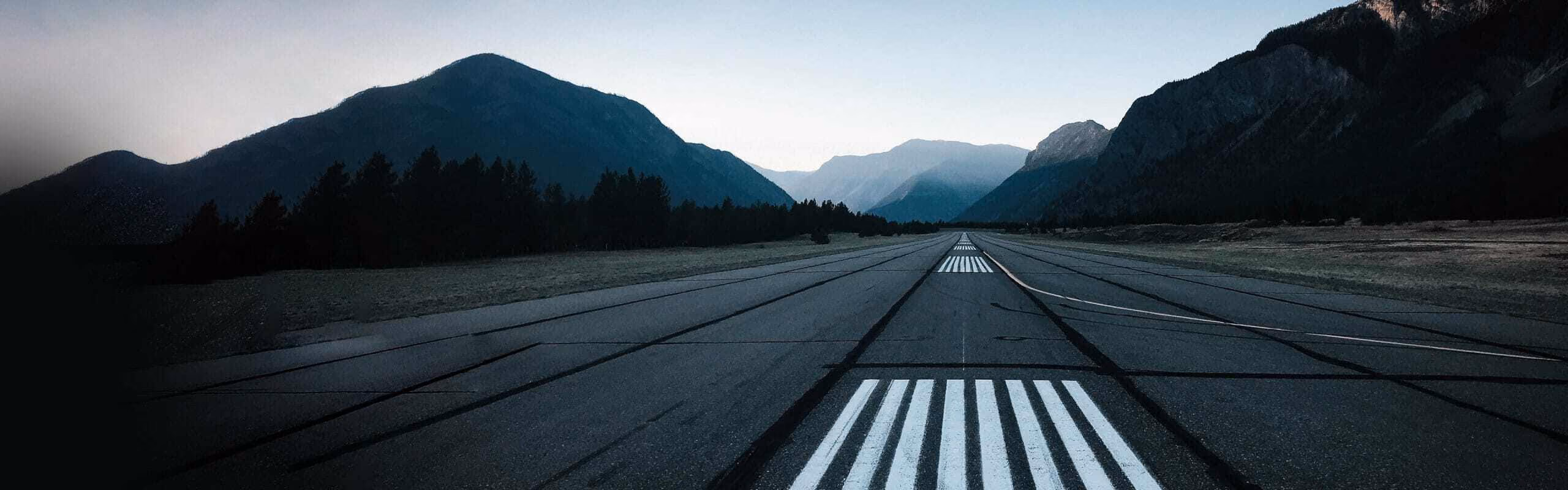 A long road with mountains on either side