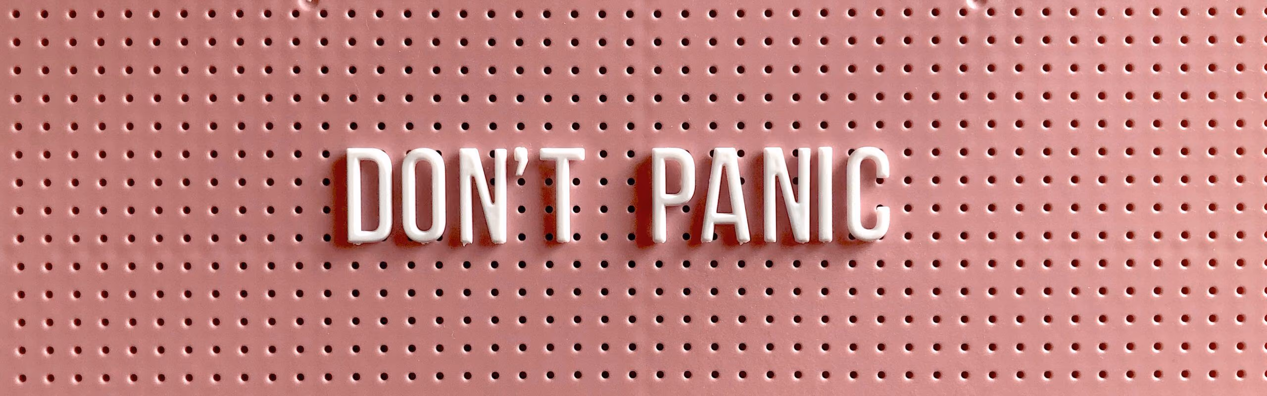 A board with the text 'Don't Panic' on it