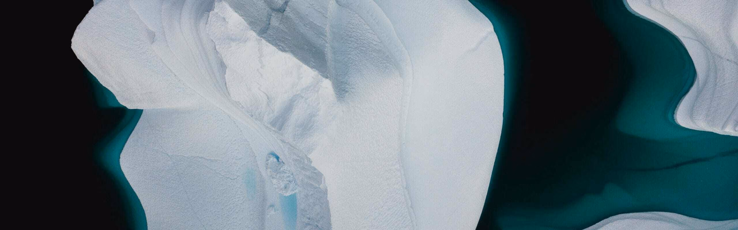 Aerial view of glaciers next to a body of water