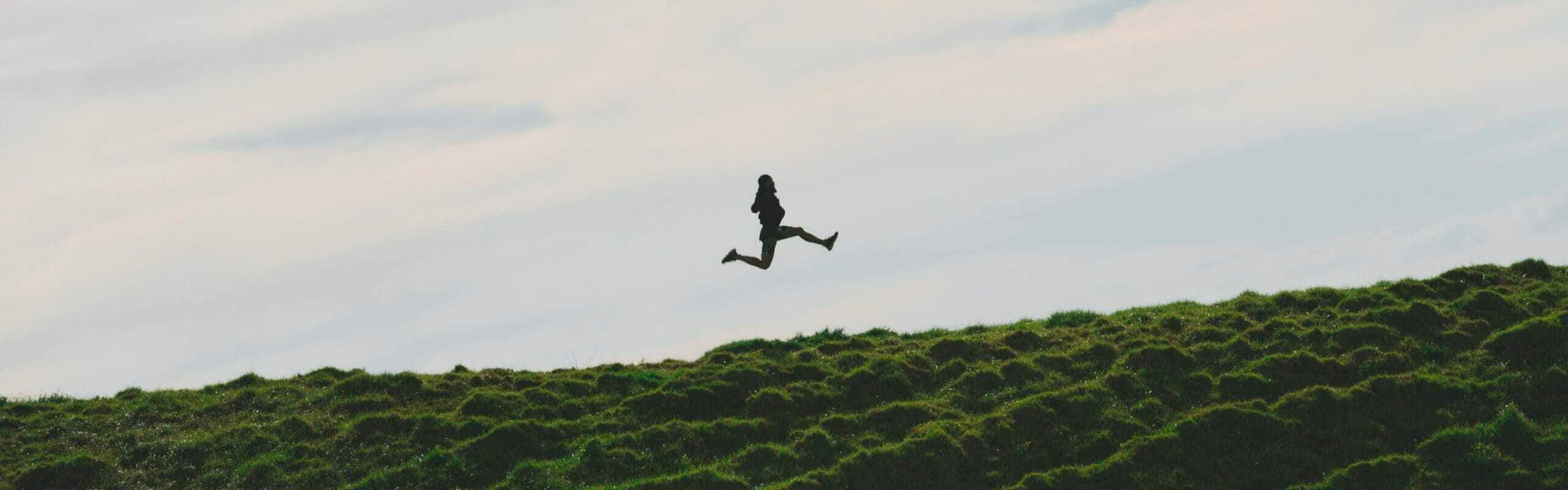 A man skipping at the top of a mountain
