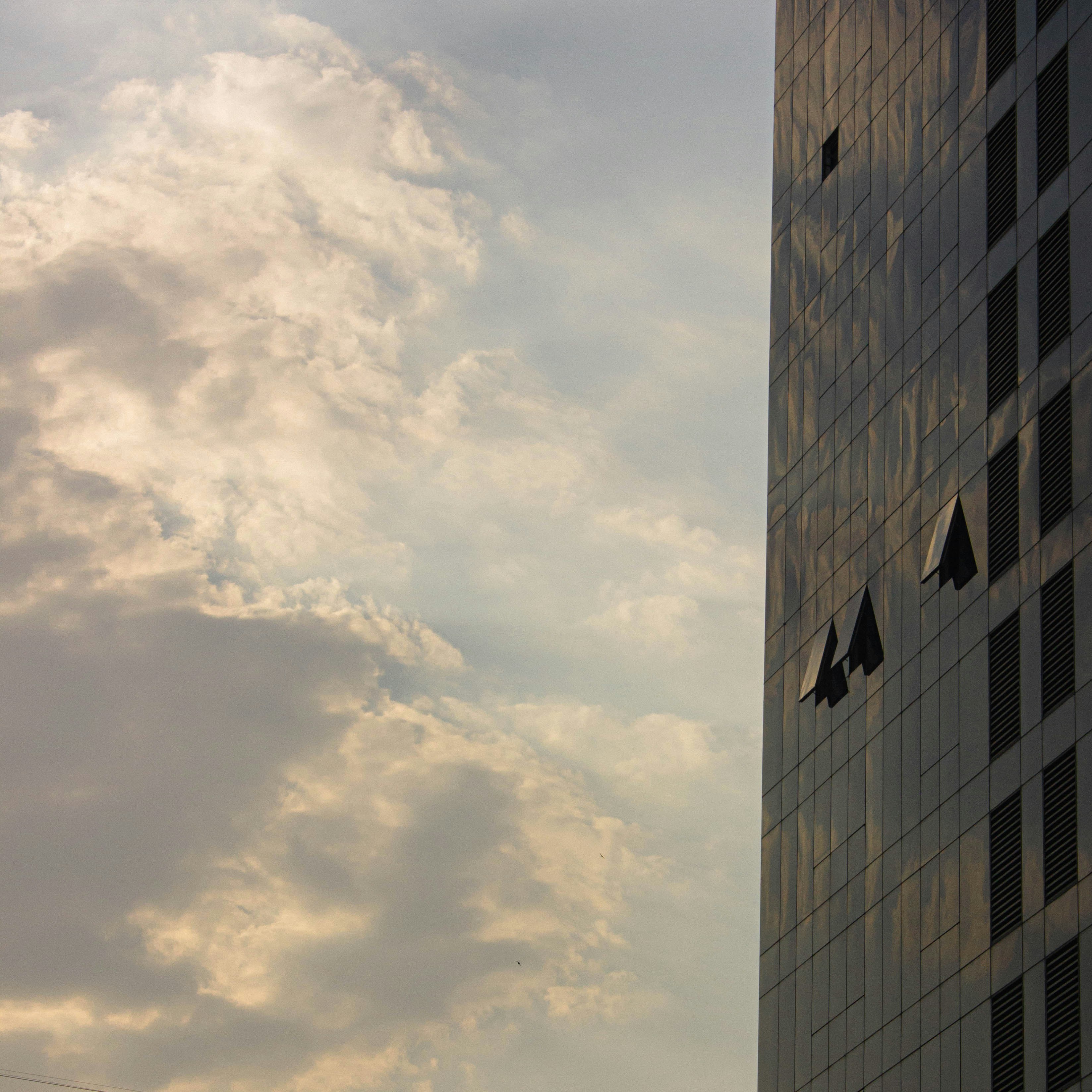 Corporate building on the right hand side of the image with an overcast sky on the left